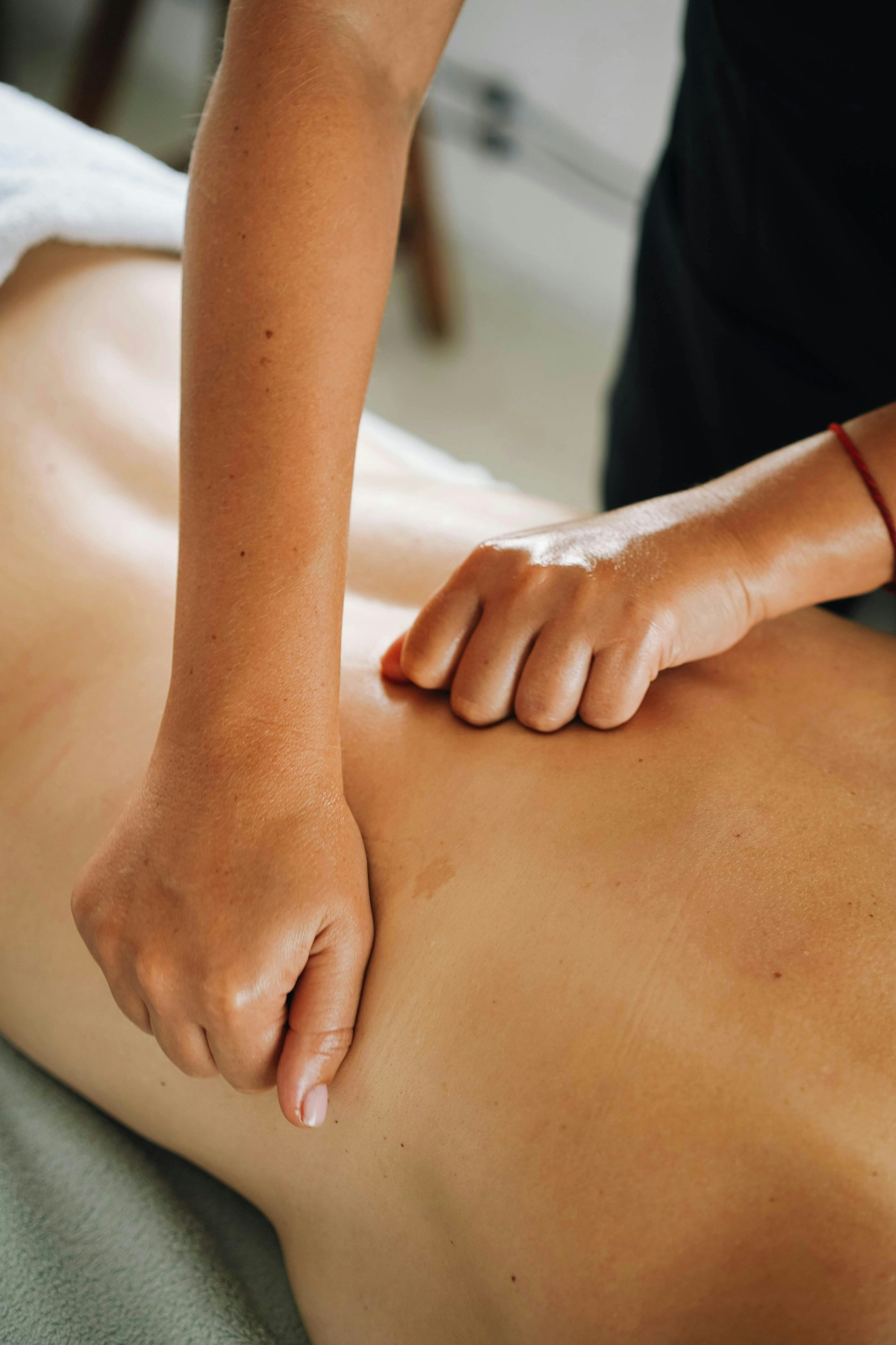 Massage therapist applying targeted pressure during a treatment